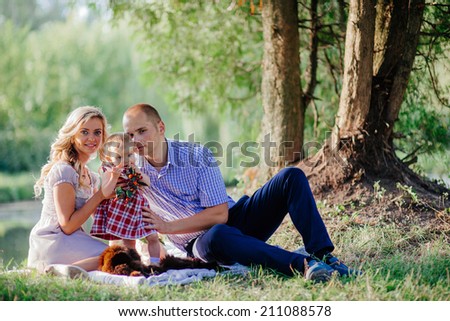 happy family are walking in the green summer park. picnic
