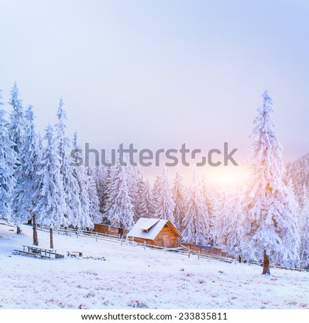 sunset in the winter mountains and fantastic chalet