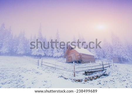 sunset in the winter mountains and fantastic chalet