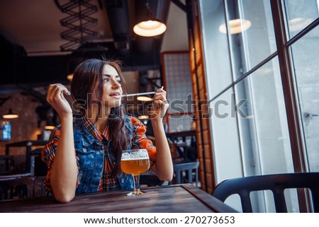 Beer woman enjoying a fresh draft beer on cafe. Art processing and retouching photos special.