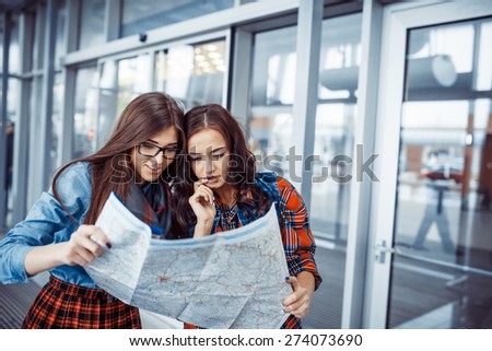 Two girlfriends looking for a route map.Art processing and retouching photos special.