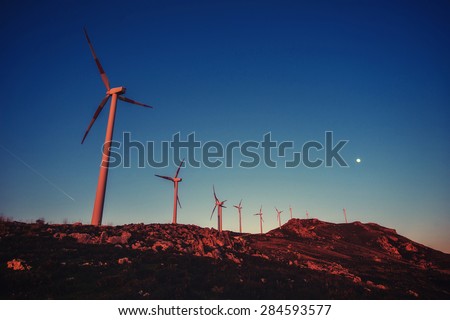 Solar wind turbines at sunset.