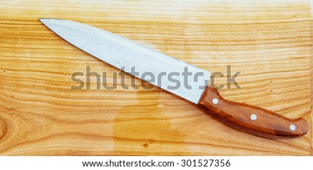 knife on an wooden cutting board