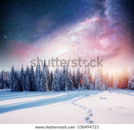 starry sky in winter snowy night. fantastic milky way in the New Year\'s Eve. The Milky Way is a fantastic New Year\'s Eve. Winter road in the mountains. Courtesy of NASA.