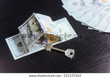 Mortgage, investment, real estate and property concept. Dollar money and house keys