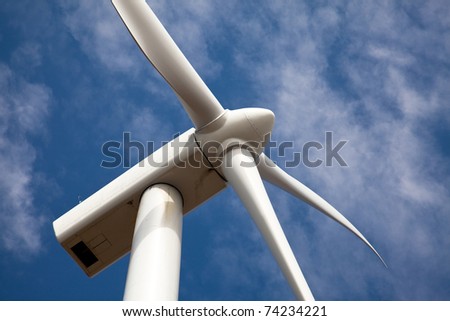 low angle view of wind turbine against partly cloudy blue sky