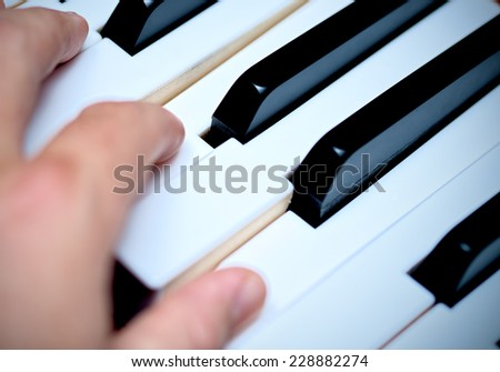 Hand and Piano Keys, Playing Piano