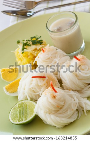 Thai traditional food,Rice vermicelli served with powdered shrimpsand, pineapple slices, boiled eggs, and coconut cream sauce.