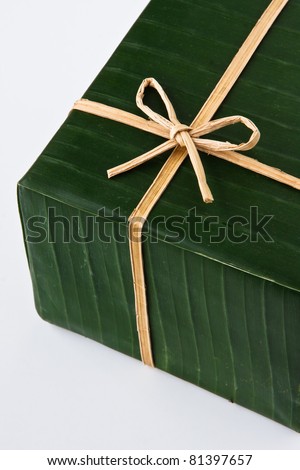 Gift box wrapped with banana leaf, ribbon and rope made from banana bark.