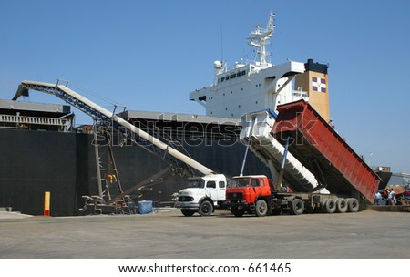 Bulk carrier vessel loading grains for export directly from trucks.