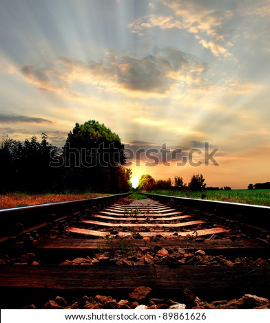 Railway in sunset, light at the end of the road