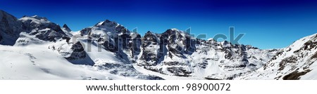 Panorama of snowy mountain ridges with blue sky in Diavolezza Switzerland