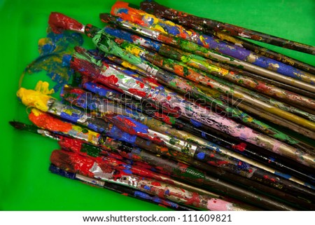 Paint brushes on a watercolor palette/Paint brushes