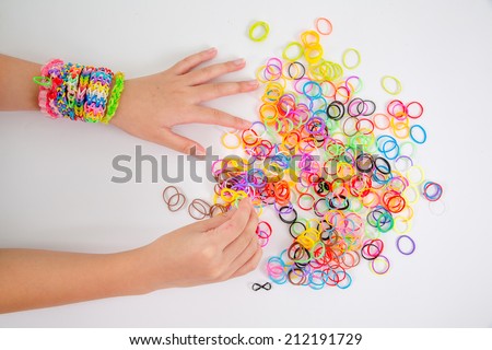 Little girl wearing colorful loom band rubber bracelet