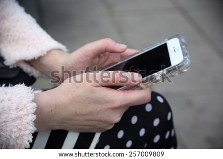 Middle-aged woman holding a cell phone