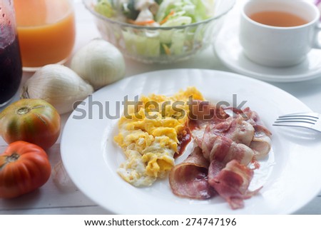 Breakfast food collage includes pancakes, eggs and bacon, biscuits, scrambled eggs, fresh blueberries,