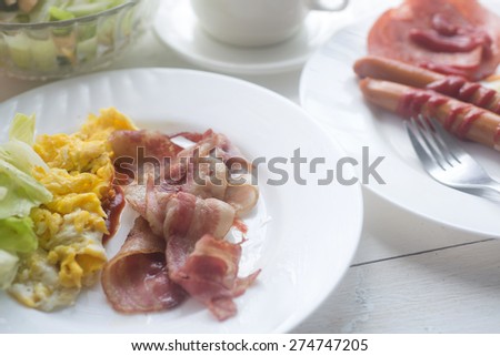 Breakfast food collage includes pancakes, eggs and bacon, biscuits, scrambled eggs, fresh blueberries,