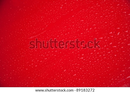 red door of car in a raining day