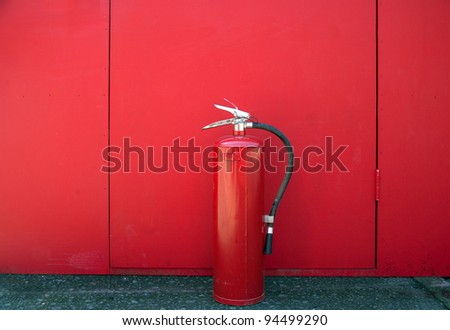 Fire extinguisher located on front of a blue door
