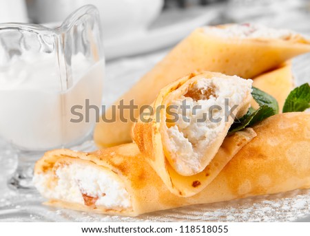 Rolled pancakes with cottage cheese and raisins