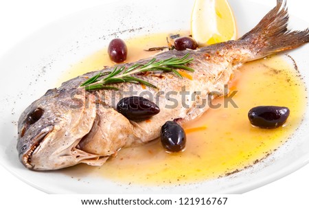 Fried fish with capers and lemon isolated on white