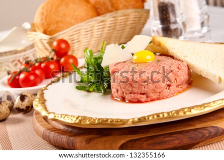 Beef tartar with parmesan cheese and small toast