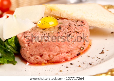 Beef tartar with parmesan cheese and small toast