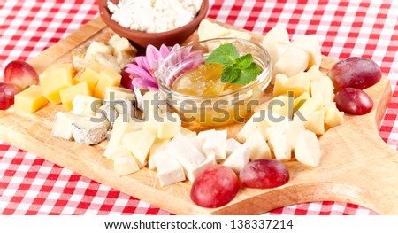 Various types of cheese on wooden platter