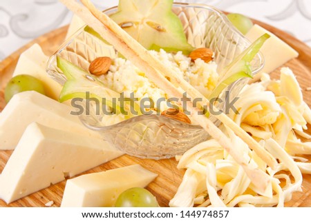 Various types of cheese on wooden platter