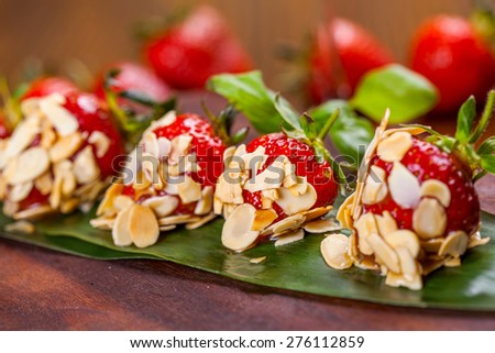 Strawberries in syrup and almond flakes