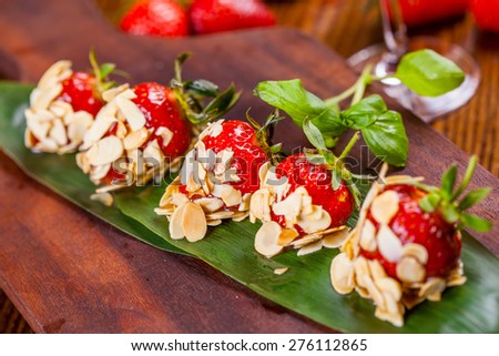 Strawberries in syrup and almond flakes
