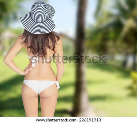 slender girl on the background on rain forest