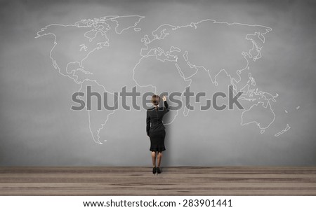 woman standing and drawing world map