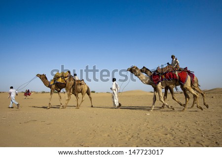 JAISALMER, INDIA - FEB 25:  Cameleer at the Sam Sand Dune on Feb 25, 2013 in Jaisalmer, India.  Apart from farming, camel riding activity for tourists is another income source for desert villagers