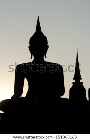 Silhouette of a sitting buddha image during sunset at Wat Mahathat, Sukhothai province