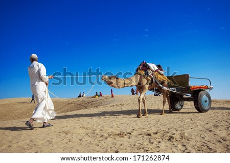 JAISALMER, INDIA - FEB 25:  Cameleer at the Sam Sand Dune on Feb 25, 2013 in Jaisalmer, India.  Camel riding activity for tourists is another income source for desert villagers.