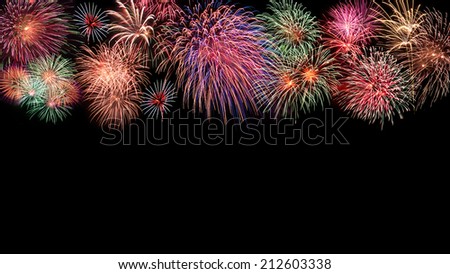 Fireworks in different shaps covering the top part of a black background