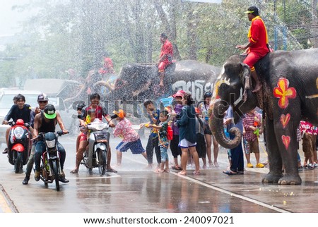 AYUTTHAYA, THAILAND - APR 13:  Revelers and elephants join in water splashing during Songkran Festival on Apr 13, 2014 in Ayutthaya, Thailand.  The water festival has been observed as Thai New Year.