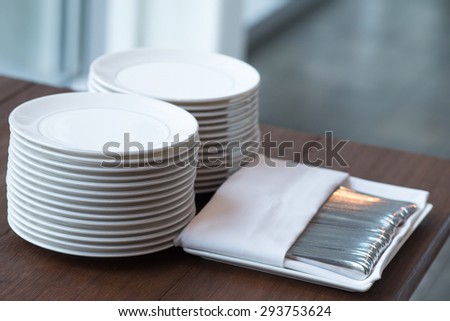 Sets of plates and silverware on a table