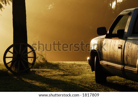 Early September morning in rural Tennessee.  Very foggy with sun-rays striking the pickup truck that is covered with heavy dew.  A very calm serene scene.