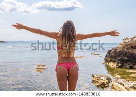 woman with open arms in the beach