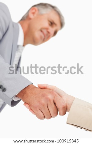 Low angle-shot of shake hands against white background
