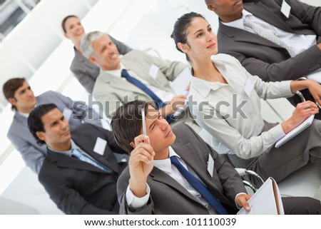 A man is asking a question at a business meeting