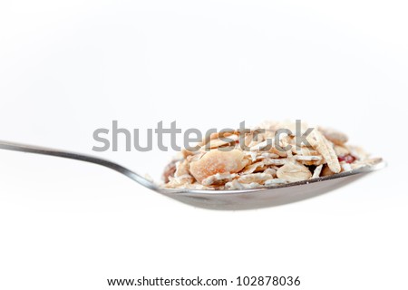 Spoon with muesli on a white background