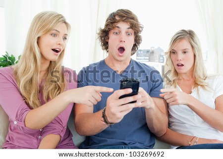 Shocked look on the boy and his friends faces as they read the text message