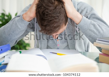 Student tearing his hair doing his homework