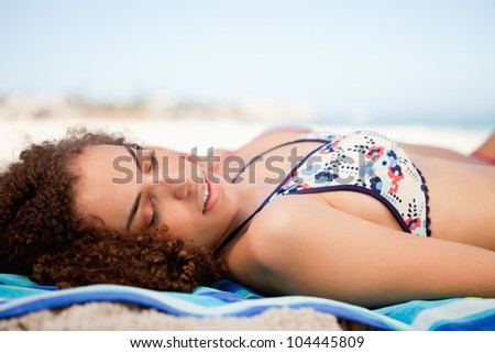 Side view of a young woman napping while turning her head on the side