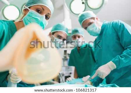 Anesthesia mask holding by a nurse in an operating theatre