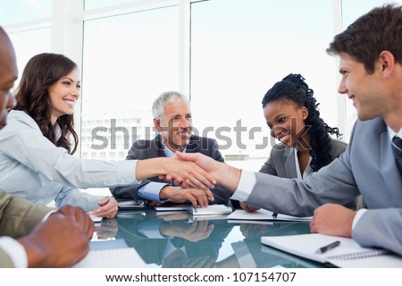 Handshake between a businesswoman and a co-worker when a meeting is ending Handshake between a businesswoman and a co-worker when a meeting is ending