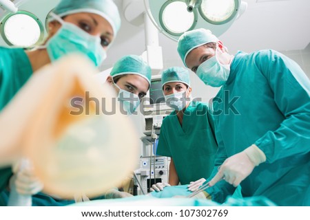 Focus on a surgical team holding an anesthesia mask in an operating theatre
